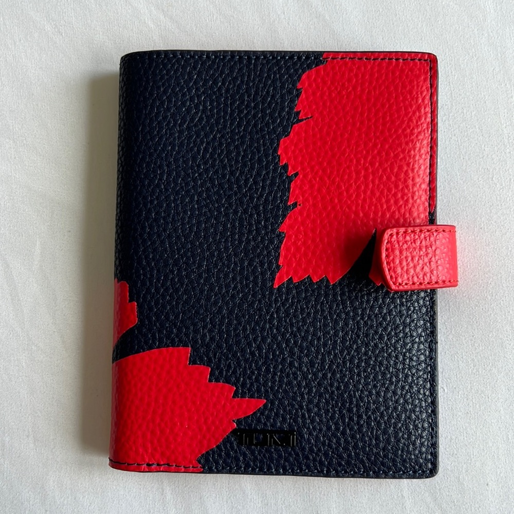 Red and blue Tumi passport case